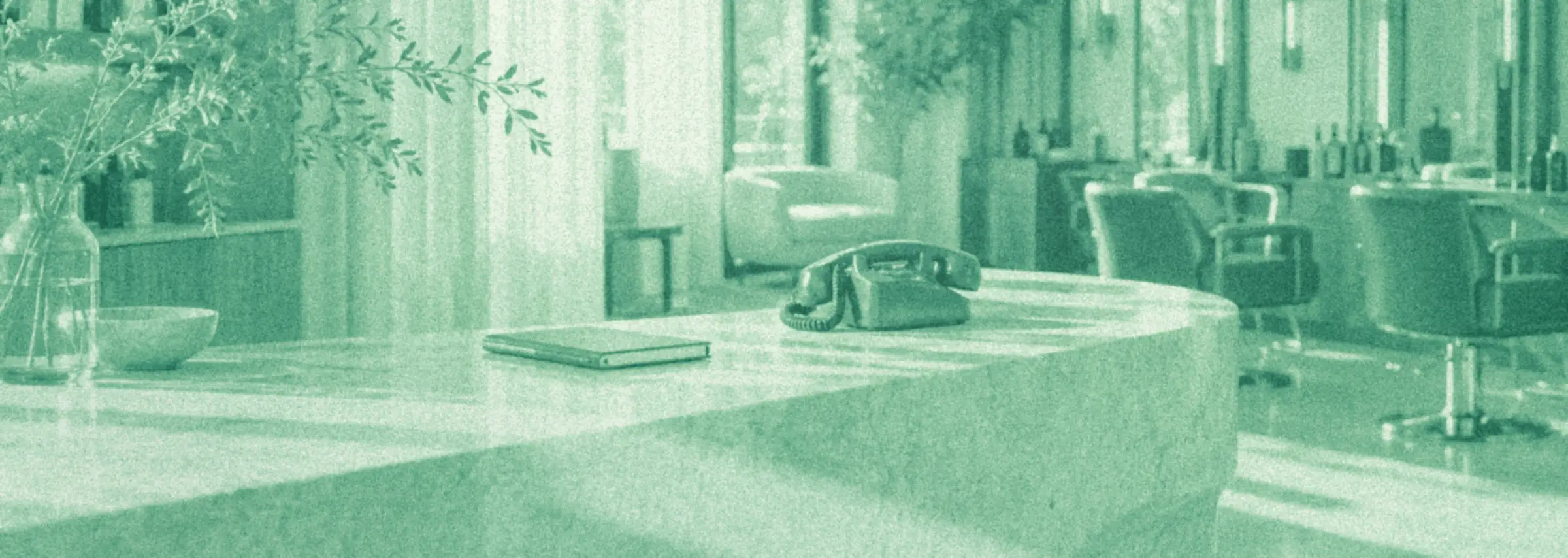 An illustrated salon front desk, with a telephone on its stone counter.